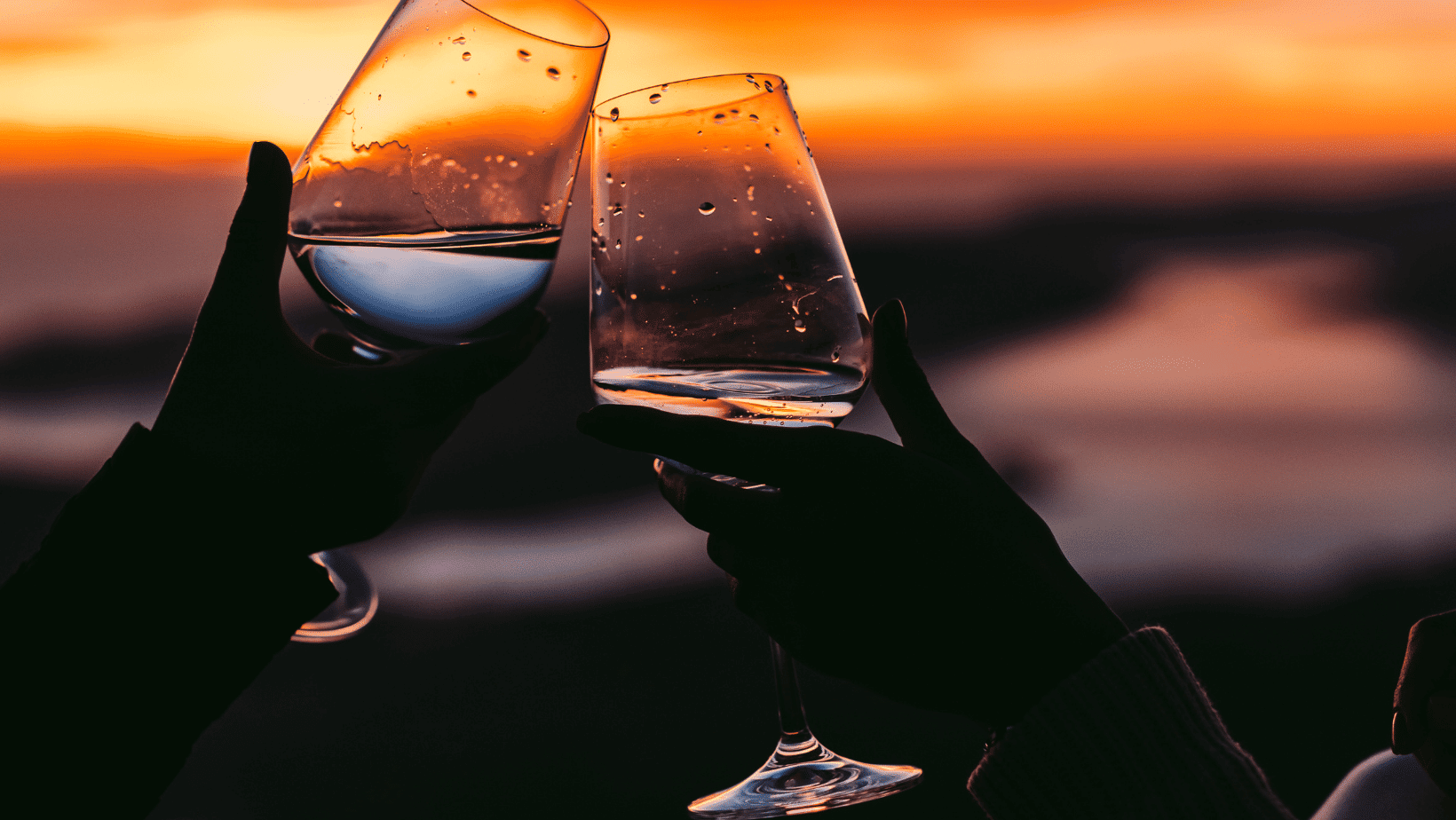 two people drinking the best CBD drinks by sunset